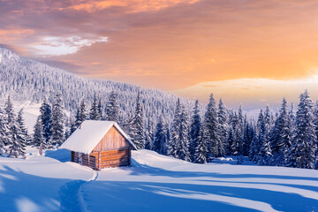 Fantastic winter landscape with wooden house in snowy mountains. Christmas holiday concept. Carpathians mountain, Ukraine, Europe