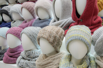 Showcase of trade tent with variety of women's hats for the autumn and winter seasons - knitted...