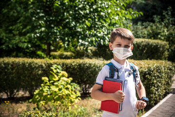 Child wearing face mask going at reopen school after covid-19 quarantine and lockdown. It is new...