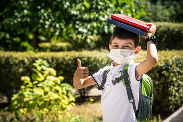 Child wearing face mask going at reopen school after covid-19 quarantine and lockdown. It is new...