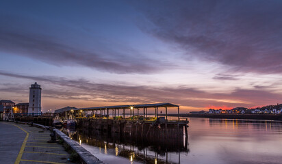North Shields Fish Quay on a calm morning during a vivid sunrise with moored Fishing boats - obrazy, fototapety, plakaty