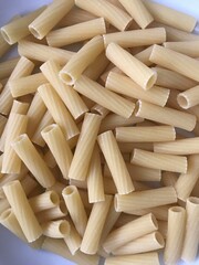 Closeup image of dry uncooked tortiglioni pasta
