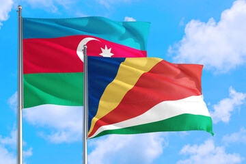 Seychelles and Azerbaijan national flag waving in the windy deep blue sky. Diplomacy and international relations concept.