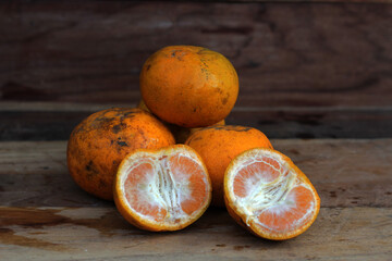 Orange fruit on brown wooden background