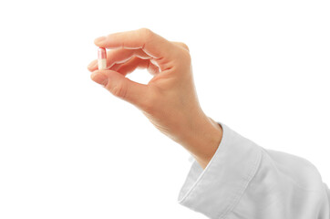 White-pink pill in caucasian female model hand on white background closeup view