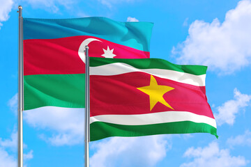 Suriname and Azerbaijan national flag waving in the windy deep blue sky. Diplomacy and international relations concept.