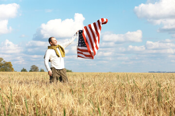 Man waving American flag standing in grass farm agricultural field , holidays, patriotism, pride, freedom, political parties, immigrant