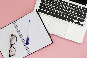 blank spiral notebook with glasses and notebook
