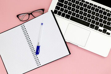 blank spiral notebook with glasses and notebook
