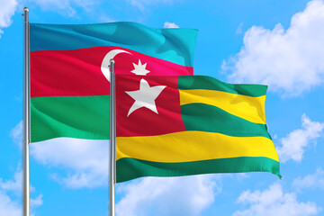 Togo and Azerbaijan national flag waving in the windy deep blue sky. Diplomacy and international relations concept.