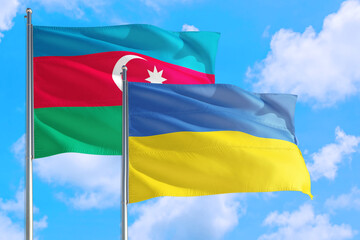 Ukraine and Azerbaijan national flag waving in the windy deep blue sky. Diplomacy and international relations concept.