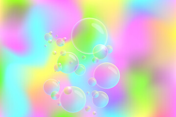 blurry pastel abstract background in pink, yellow, green and blue with bubbles