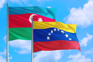 Venezuela and Azerbaijan national flag waving in the windy deep blue sky. Diplomacy and international relations concept.