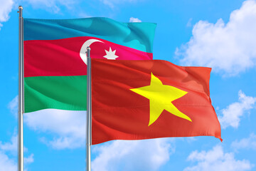 Vietnam and Azerbaijan national flag waving in the windy deep blue sky. Diplomacy and international relations concept.