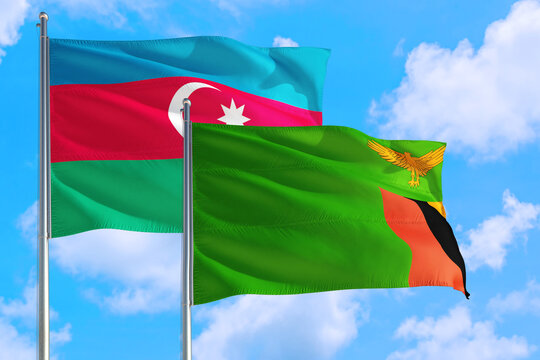 Zambia and Azerbaijan national flag waving in the windy deep blue sky. Diplomacy and international relations concept.