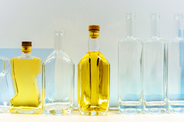 Glass bottles are empty and with alcohol on the shelf. The demonstration of glass products at an industrial exhibition. Close-up