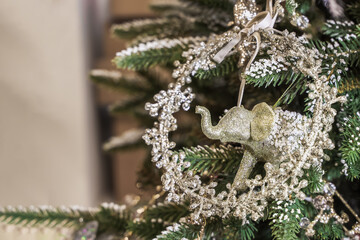 Christmas tree decorating, Christmas elephant bright toy on the pine tree background