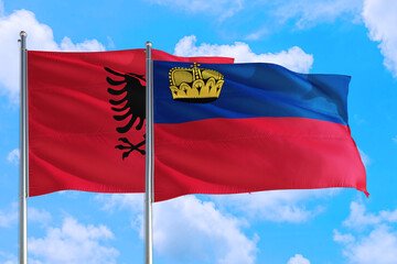 Liechtenstein and Albania national flag waving in the windy deep blue sky. Diplomacy and international relations concept.