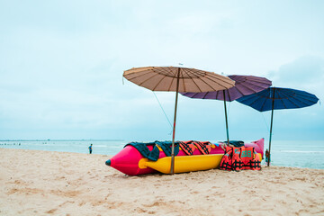 banana boat and life jacket lays on the beach.