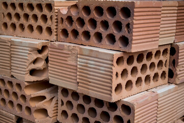 stacked clay bricks for building construction