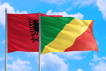 Republic Of The Congo and Albania national flag waving in the windy deep blue sky. Diplomacy and international relations concept.