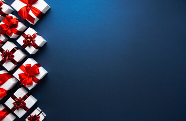 White gifts with red ribbon, present on blue background top view. Happy Holidays. Valentine's day....