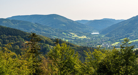 Fototapeta na wymiar Moravka village with water reservoir and hills around in Czech republic