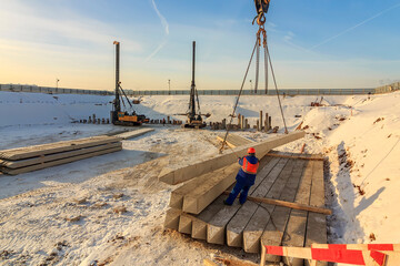 Pile driving in foundation pit. construction of apartment building. Piling driven in ground. Deep...