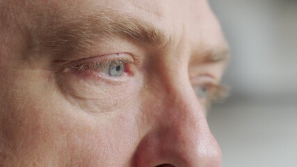 Old man's eyes closeup footage: pensive old man thoughtful elder