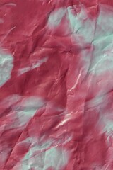 Abstract background of mixed pale blue and cherry plum marbled nail polish. Crumpled paper effect with two-tone color transition