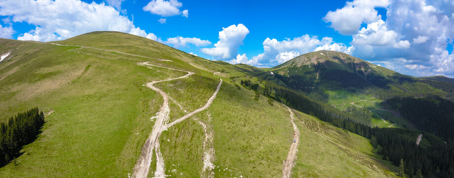 Aerial Drone view of Balota Peak and the pastures and forests surrounding it. Capatanii Massif, Carpathians, Romania