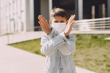 Boy in a city. Person in a mask. Coronavirus theme.