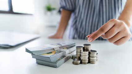 Business person holding and stacking coins on the table, future investment, retirement.