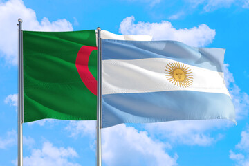 Argentina and Algeria national flag waving in the windy deep blue sky. Diplomacy and international...