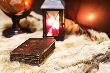 Retro old book and world desk globe on fur, learning and education concepts.