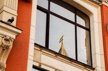 Reflection of the dome of a historic building in a windoww, the Russian-concept of communication of architectural styles.
