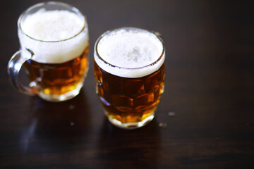 Glass of fresh beer on a wooden table. Lager beer mug on stone table. Top view with copy space