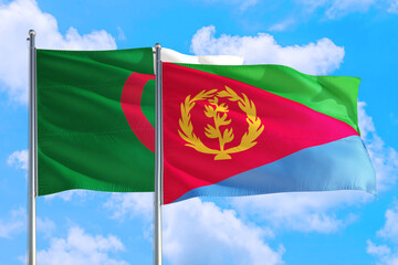 Fototapeta na wymiar Eritrea and Algeria national flag waving in the windy deep blue sky. Diplomacy and international relations concept.