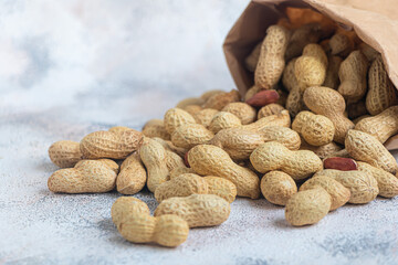 Peanuts. Contains beneficial vitamins and minerals. On a gray background.