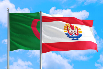 French Polynesia and Algeria national flag waving in the windy deep blue sky. Diplomacy and international relations concept.