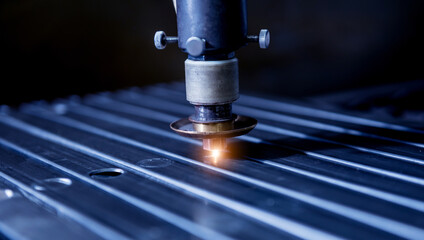 The laser cutting machine cutting the holes on pipes
