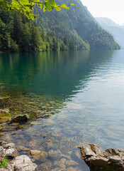 Berchtesgaden lake K&ouml;nigssee with trees in foreground and mountains in the background