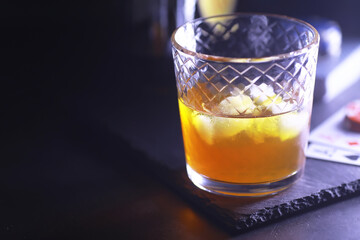 Gambling Card games for money. Texas Hold'em Poker. Cards in hand, playing chips, deck of cards of alcohol in a glass.