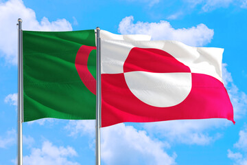 Greenland and Algeria national flag waving in the windy deep blue sky. Diplomacy and international relations concept.