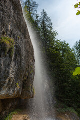 Berchtesgaden waterfall under the cliffs on a summer day at lake K&ouml;nigssee