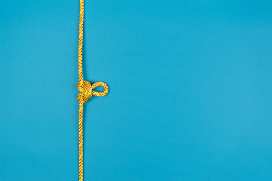 Butterfly Loop Knot With Yellow Climbing Rope On Blue Background