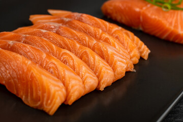 Slices of Raw Salmon Fillet on Black Background