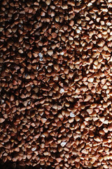 A set of grain cereals. Rice, buckwheat and millet groats in a wooden tray. A grocery set of cereals. Import of grain.