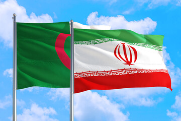 Iran and Algeria national flag waving in the windy deep blue sky. Diplomacy and international...