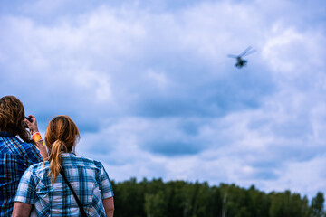 An army helicopter flying over a training battlefield